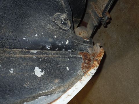2001 Ford Crown Victoria - This close-up shows extensive rust damage on the undercarriage of a vehicle, obscuring any specific year or model identification.