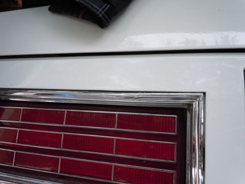 2001 Ford Crown Victoria - Detail of a vehicle's rear lighting system, showing red reflectors and chrome accents.