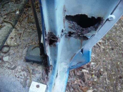 1979 Ford Bronco - Significant rust damage is visible on the vehicle's door frame, showing extensive decay.
