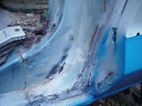 1979 Ford Bronco - Extensive rust damage is evident on the door sill and rocker panel of this vehicle, indicating significant deterioration.