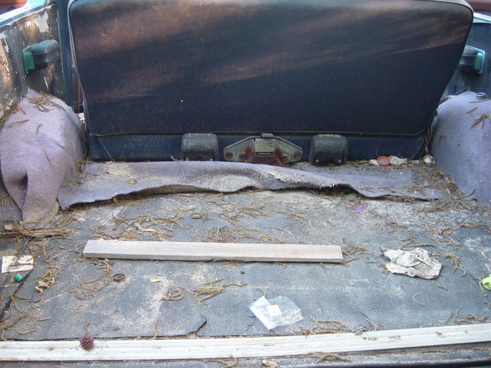 Interior cargo area with dirty floor and folded seat