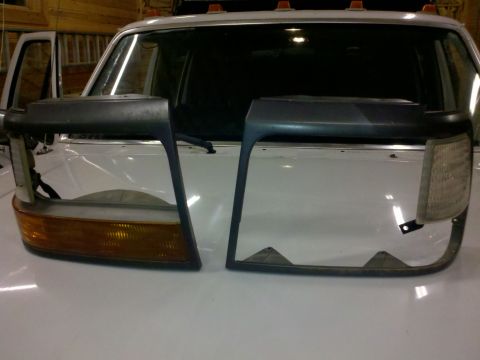 1979 Ford Bronco - Disassembled headlight assemblies are shown, with one unit an amber turn signal.