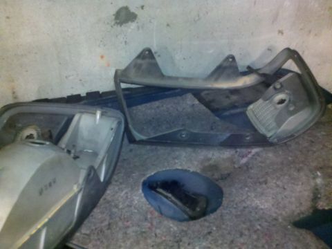 1979 Ford Bronco - Disassembled car parts are laid out on a carpeted floor.