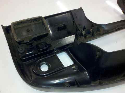 1979 Ford Bronco - This is a close-up view of a black plastic automotive interior trim component, likely from a dashboard or console.