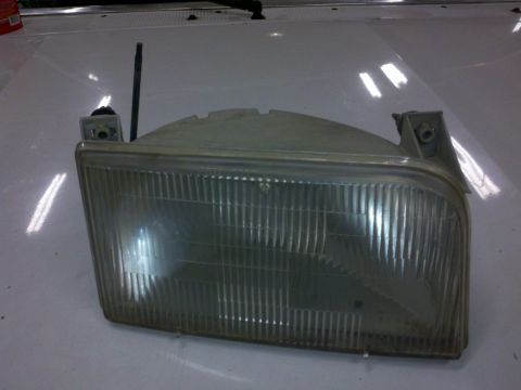 1979 Ford Bronco - A single headlight assembly is shown, detached from a vehicle.