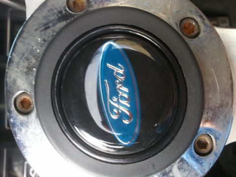 1978 Ford Bronco - Close-up of a Ford emblem on a steering wheel, indicating a Ford vehicle.