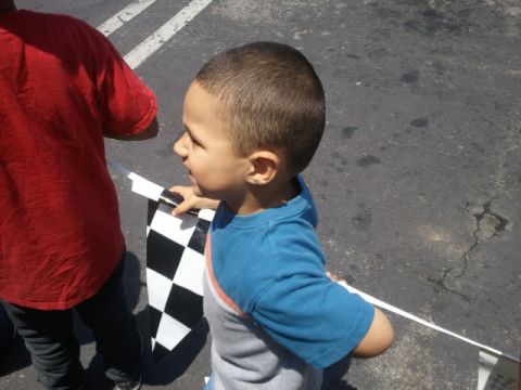 1978 Ford Bronco - A child holds a checkered flag, ready for a race to begin.