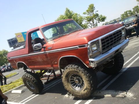 1978 Ford Bronco - This lifted 1978 Ford Bronco is parked at an angle in a parking lot.