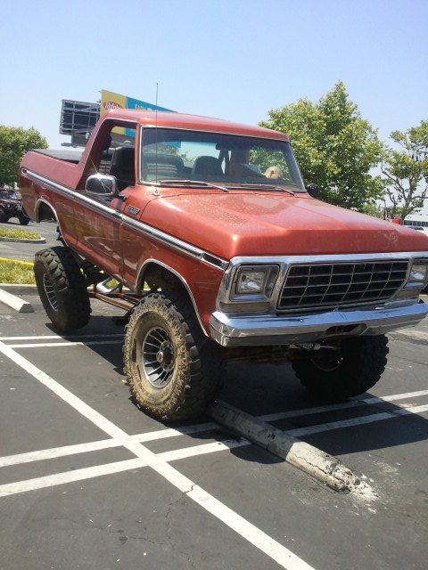 1978 Ford Bronco - This lifted 1978 Ford Bronco is parked with its front tire on a concrete parking stop.