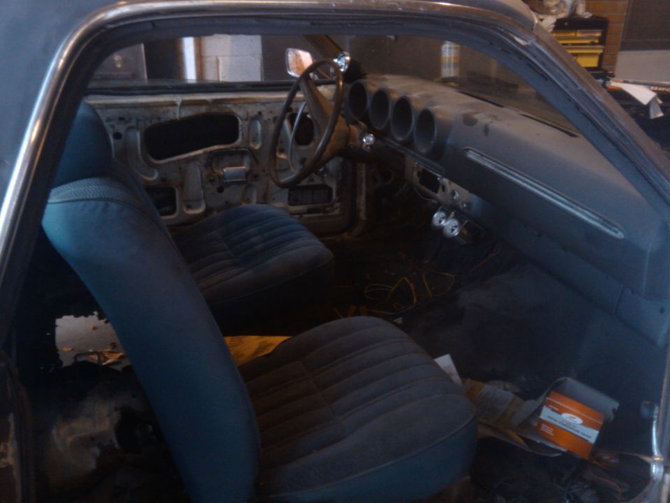 Interior of a 1969 Ford Ranchero showing blue seats and dashboard with three circular vents
