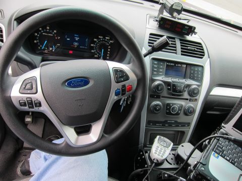 1991 Ford LTD Crown Victoria - Ford steering wheel and center console fitted with a police radio control head, keypad and laptop mount.