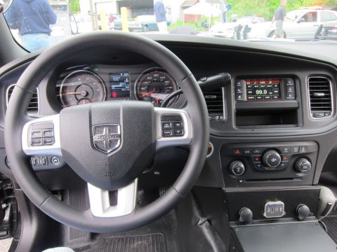 1991 Ford LTD Crown Victoria - interior of a Dodge with its ram-head steering wheel emblem, twin gauges, and a center radio screen reading 99.9.
