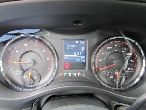 1991 Ford LTD Crown Victoria - close-up Dodge instrument cluster with twin gauges, a digital display reading coolant temp and 3521 miles, and PRND selector.