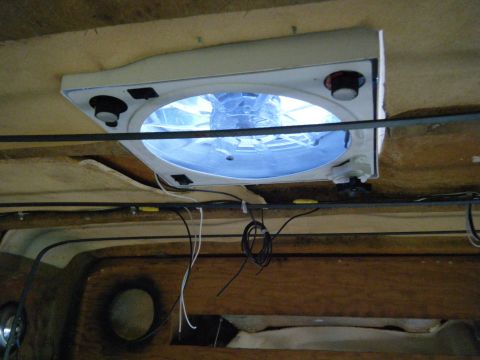 1981 Ford E350 - A ceiling fan with blue illumination is installed inside a vehicle's interior, with exposed wiring visible.