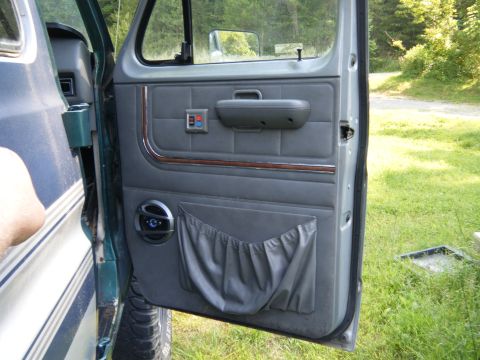 1981 Ford E350 - The interior door panel shows a speaker, map pocket, and window controls.