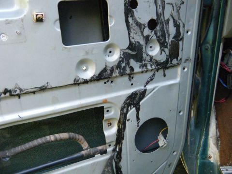 1981 Ford E350 - Vehicle door interior panel with wiring and sound deadening material visible.