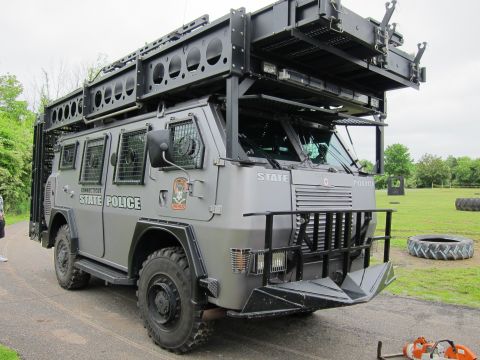 1991 Ford LTD Crown Victoria - Front three-quarter view of a gray Connecticut State Police armored tactical truck with a brush guard and roof rack.