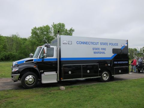 1991 Ford LTD Crown Victoria - Driver-side view of a black and silver Connecticut State Police State Fire Marshal box truck parked on grass.