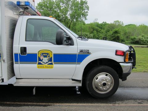1991 Ford LTD Crown Victoria - Close-up of the cab of a white Ford F-550 Connecticut State Police truck showing the 1903 state police shield decal.