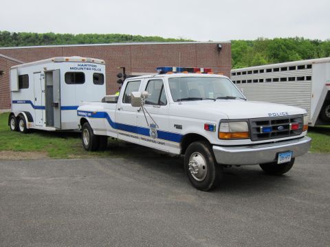 1991 Ford LTD Crown Victoria - Front three-quarter view of a white Ford Hartford Police pickup truck towing a Hartford Mounted Police horse trailer.