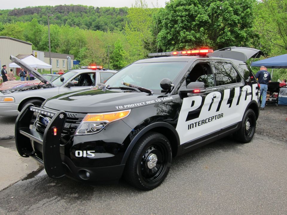 Black and white Ford Police Interceptor Utility SUV at outdoor event