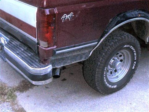 1990 Ford Bronco - Rear view of a 1990 Ford Bronco showing the taillight, bumper, and a BFGoodrich All-Terrain tire.