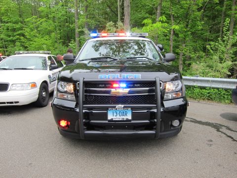 1991 Ford LTD Crown Victoria - Front view of a black Chevrolet Tahoe police SUV with a pushbar, roof lightbar, and POLICE lettering on the hood.