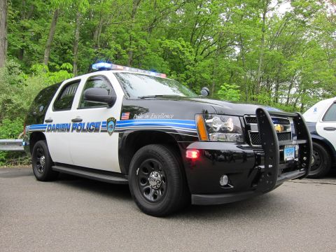 1991 Ford LTD Crown Victoria - Front three-quarter view of a black-and-white Chevrolet Tahoe lettered DARIEN POLICE with pushbar and roof lightbar.
