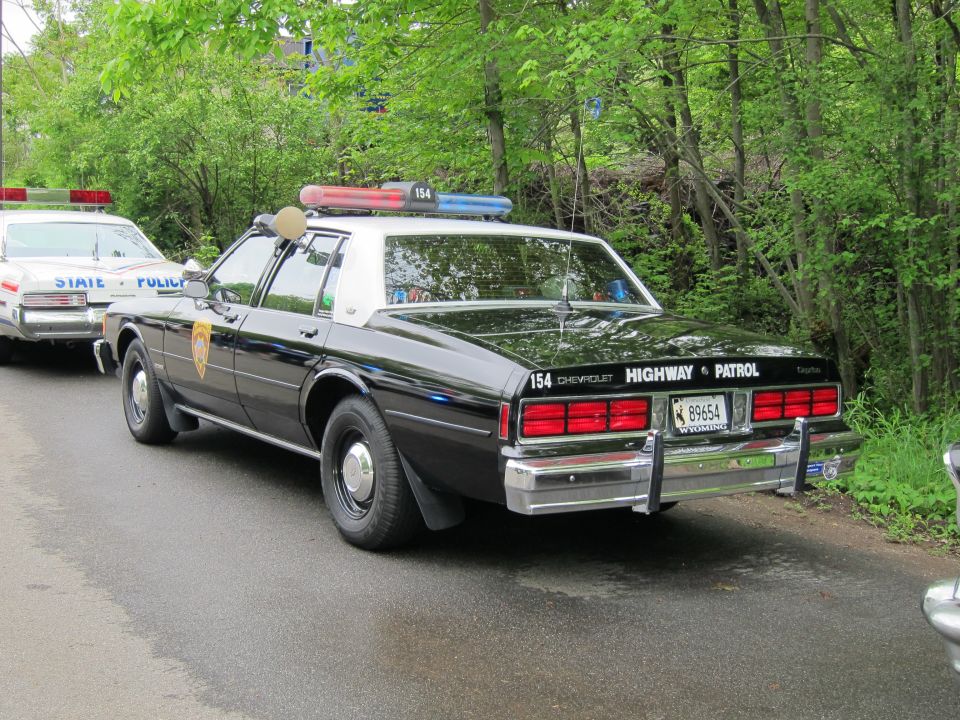 Black and white Chevrolet Caprice Highway Patrol police car, rear three-quarter view