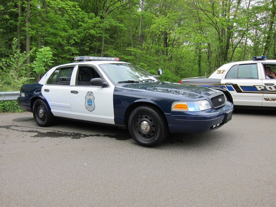 Blue and white Ford Crown Victoria police car, front three-quarter view