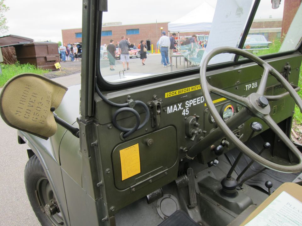 Olive-green military jeep dashboard and mirror with MAX SPEED 45 stencil