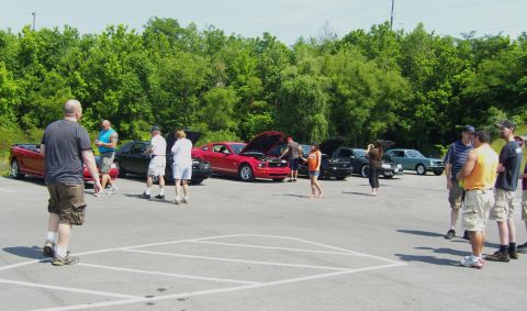2007 Ford Mustang - Several Ford Mustangs are gathered at a regional meet, with hoods open for display.