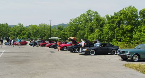 2007 Ford Mustang - Several Ford Mustangs are gathered at a regional meet, with a 1967 model in the foreground.