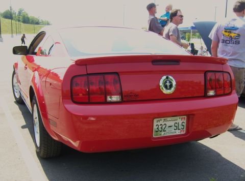 2007 Ford Mustang - Rear view of a red 2007 Ford Mustang, its distinctive taillights and a spoiler.