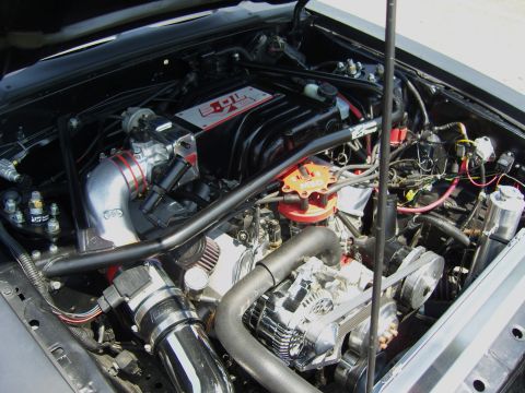2007 Ford Mustang - Close-up view of a modified engine bay, showing various engine components and wiring.