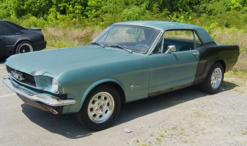 2007 Ford Mustang - A classic Ford Mustang coupe, partially repainted, sits outdoors with another vehicle nearby.