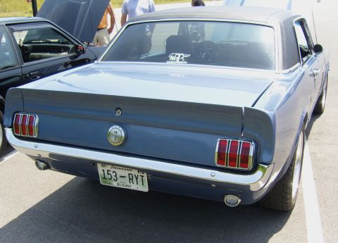 2007 Ford Mustang - A blue classic Mustang is parked at an outdoor event, with another vehicle nearby.