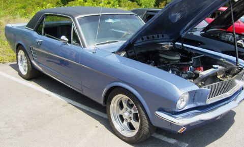 2007 Ford Mustang - A blue 1965 Ford Mustang coupe is parked with its hood open, revealing the engine compartment.