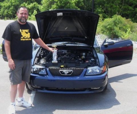 2007 Ford Mustang - Man with trophy poses with his blue Ford Mustang, hood and door open.