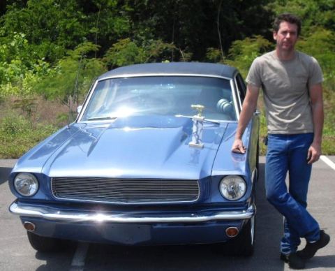 2007 Ford Mustang - A man poses with a vintage blue car, which has a trophy displayed on its hood.
