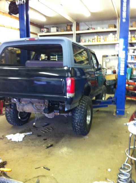 1993 Ford Bronco - This Ford Bronco is on a lift in a garage, undergoing some work with its rear bumper removed.