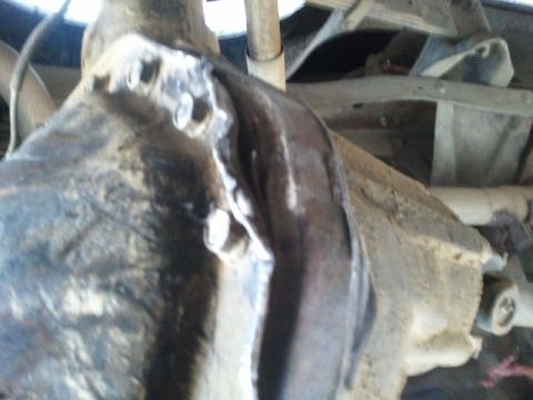 1978 Ford Bronco - Close-up view of a vehicle's undercarriage, focusing on mechanical parts and frame structure.