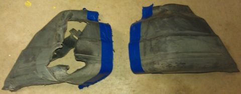1991 Ford Festiva - Two black plastic automotive parts are shown, held together with blue tape.