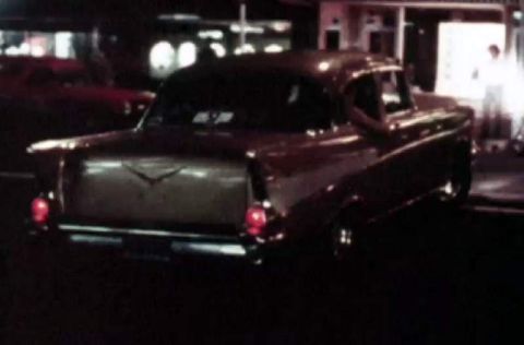 1969 Lincoln Continental - A classic 1957 Chevrolet Bel Air is seen from the rear, its iconic tail fins and chrome details.
