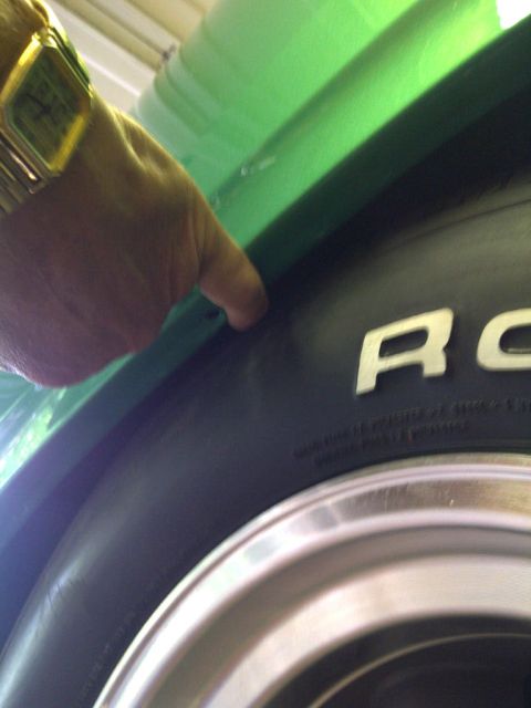 1971 Ford Ranchero - Close-up of a green vehicle's fender and tire, with part of the tire sidewall visible.