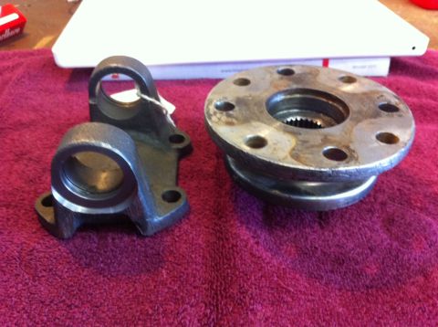 1987 Suzuki Samurai - Close-up of two driveshaft U-joint parts, likely for repair or replacement.