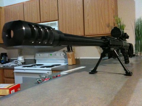 1996 Ford Bronco - A sniper rifle with a scope and bipod is positioned on a kitchen counter, with a stove visible in the background.