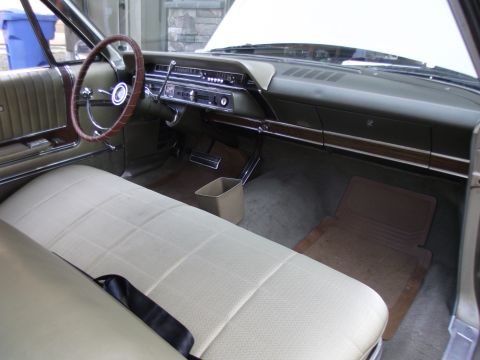 1965 Ford Galaxie - Interior view of a car, showing the dashboard, steering wheel, and seats.