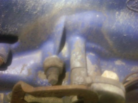 1989 Ford Bronco - This image shows a close-up of a rusty metal part with chipped blue paint, not a 1989 Ford Bronco.