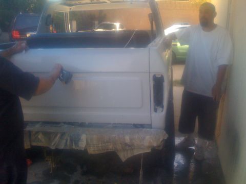 1978 Ford Bronco - A white SUV with a black soft top is being detailed in this rear view shot.